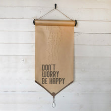 Don't Worry Be Happy piano roll.  Our vintage piano roll sign adds unique charm and one-of-a-kind gift giving for the music lover in your life!  D E T A I L S • Each piano roll is vintage and has flaws and character from use and age. • Twine included for hanging. • Black ink printed on piano roll. • Glass crystal included as adornment. • 12" wide x 29" long.