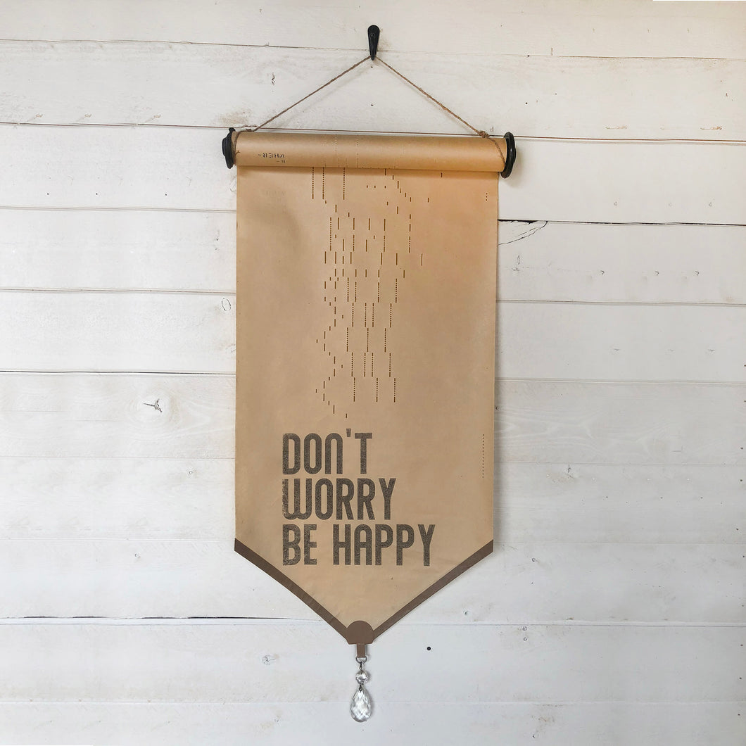 Don't Worry Be Happy piano roll.  Our vintage piano roll sign adds unique charm and one-of-a-kind gift giving for the music lover in your life!  D E T A I L S • Each piano roll is vintage and has flaws and character from use and age. • Twine included for hanging. • Black ink printed on piano roll. • Glass crystal included as adornment. • 12